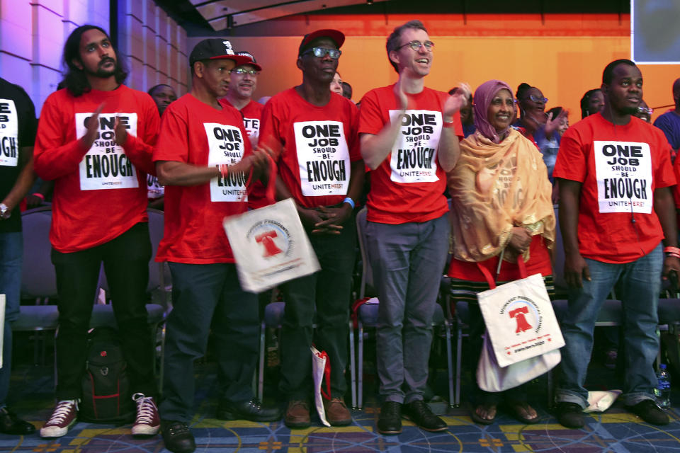 Union members of UNITE HERE stand during the opening of the first-ever "Workers' Presidential Summit" at the Convention Center in Philadelphia, Tuesday, Sept. 17, 2019. The Philadelphia Council of the AFL-CIO hosted the event. (Tom Gralish/The Philadelphia Inquirer via AP)