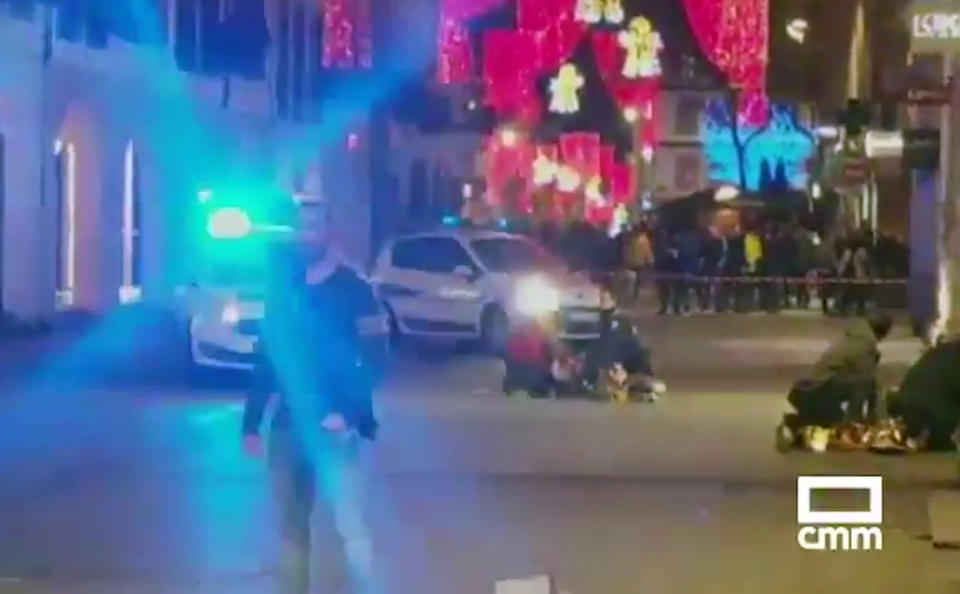 In this image made from video provided by CMM, people lay on the ground after a shooting at a Christmas market in Strasbourg, France, Tuesday, Dec. 11, 2018. A French regional official says that a shooting in Strasbourg has left at least one dead and several wounded in the city center near a world-famous Christmas market. The prefect of France's Bas-Rhin region says the gunman, who is still at large, has been identified. Authorities haven't given a motive for the shooting. (CMM via AP)