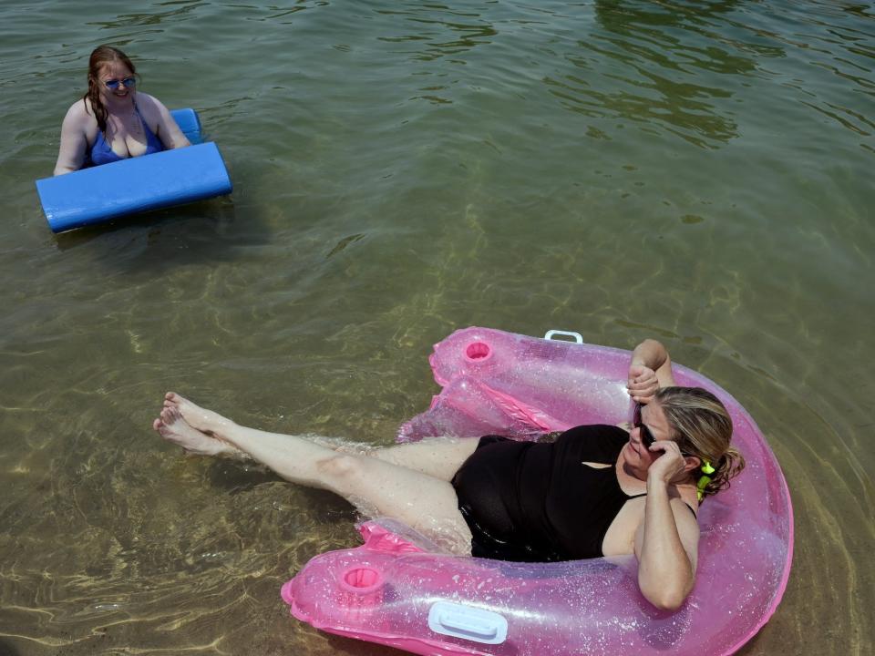 Sarah Bulat (L) and Tricia Watts relax in the water during a heat wave in Lake Havasu, Arizona, U.S. June 15, 2021.