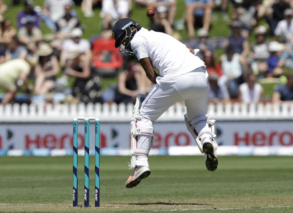 Sri Lanka's Dimuth Karunaratne reacts as he is hit while batting during play on day one of the first cricket test against New Zealand in Wellington, New Zealand, Saturday, Dec. 15, 2018. (AP Photo/Mark Baker)