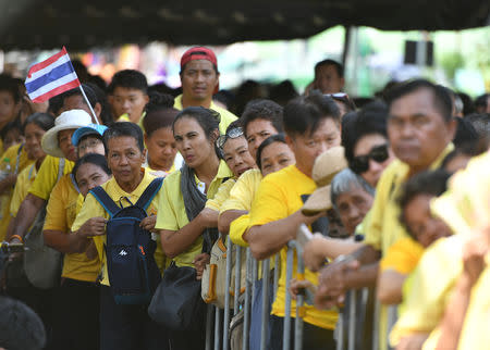People stand in line to pass through a security check before attending a coronation procession for Thailand's newly crowned King Maha Vajiralongkorn in Bangkok, Thailand May 5, 2019. REUTERS/Chalinee Thirasupa
