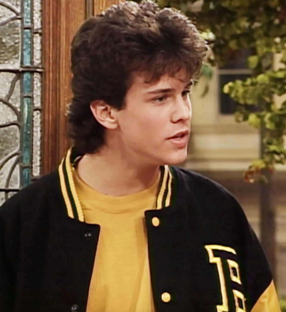 closeup of the character wearing a letterman jacket