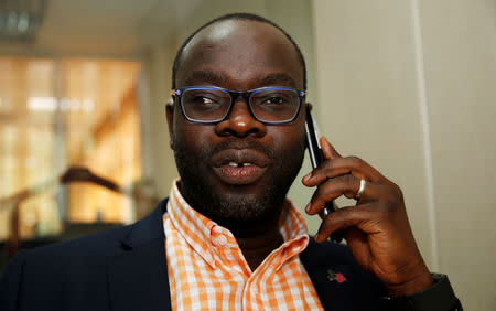 Kibera constituency's first parliamentarian, Kenneth Okoth, talks on his cell phone after an interview with the Thomson Reuters Foundation in Kenya's capital Nairobi, October 24, 2016. REUTERS/Thomas Mukoya