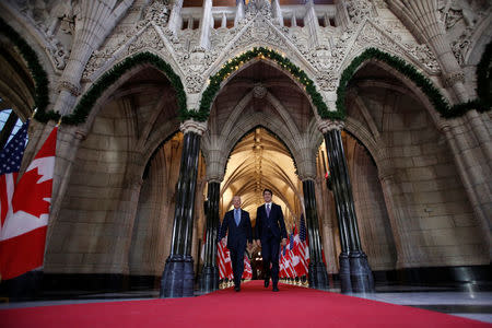 Canada's Prime Minister Justin Trudeau (R) walks with U.S. Vice President Joe Biden following a meeting on Parliament Hill in Ottawa, Ontario, Canada, December 9, 2016. REUTERS/Chris Wattie