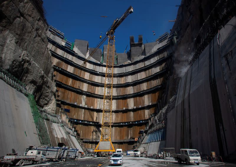 FILE PHOTO: Crane is seen near the dam of Wudongde hydropower plant under construction, on the Jinsha River