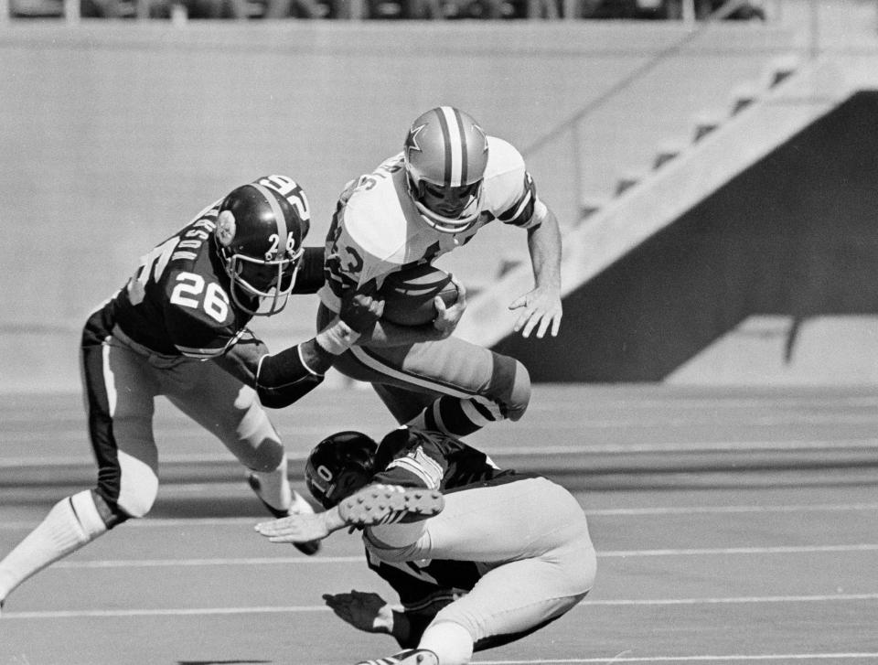 File-This Oct. 8, 1972, file photo shows Dallas Cowboys safety Cliff Harris (43) making a 45-yard return on a second quarter punt Oct. 8, 1972 in Irving, Texas before being brought down by Steelers' Preston Pearson (26) and Roy Gerela (10). Harris and receiver Drew Pearson, who also will be inducted this year as part of the class of 2021, are the first undrafted Cowboys among their 15 players in the Hall of Fame.(AP Photo/File)