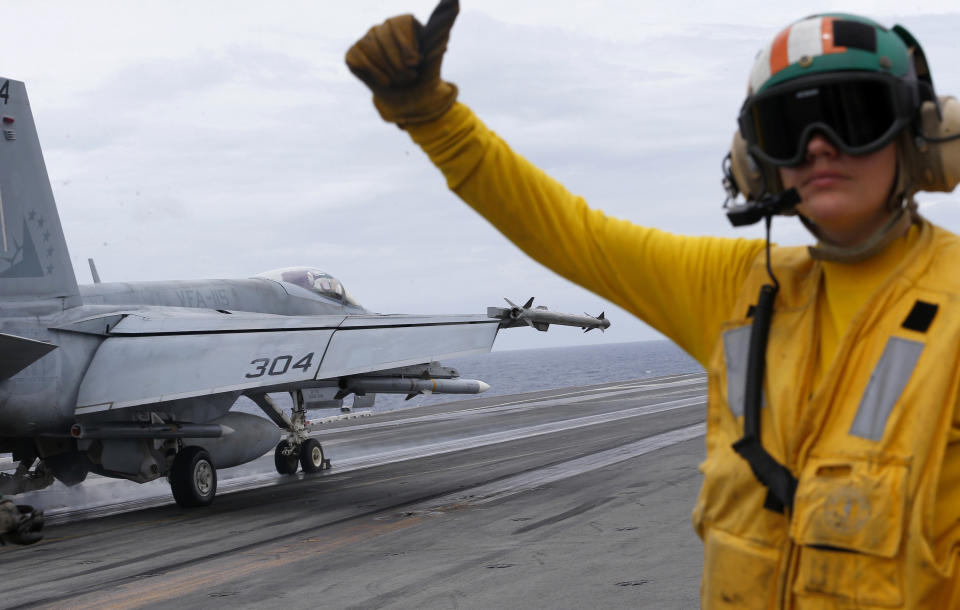 A U.S. fighter jet takes off from the U.S. aircraft carrier USS Ronald Reagan for their patrol at the international waters off South China Sea Tuesday, Aug. 6, 2019. The U.S. aircraft carrier has sailed through the disputed South China Sea in the latest show of America's military might amid new territorial flareups involving China and three rival claimant states as Philippines, Vietnam and Malaysia. (AP Photo/Bullit Marquez)