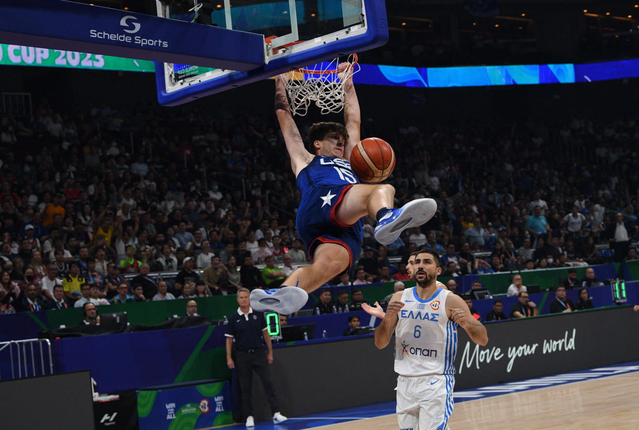 US' Austin Reaves (L) dunks the ball during the FIBA Basketball World Cup group C match between US and Greece at the Mall of Asia Arena in Pasay city, suburban Manila on August 28, 2023. (Photo by Ted ALJIBE / AFP) (Photo by TED ALJIBE/AFP via Getty Images)