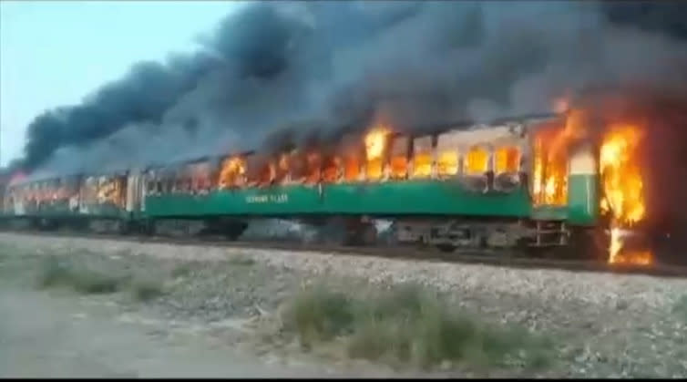 Video grab of a fire burning in a train carriage after a gas canister passengers were using to cook breakfast exploded, near the town of Rahim Yar Khan