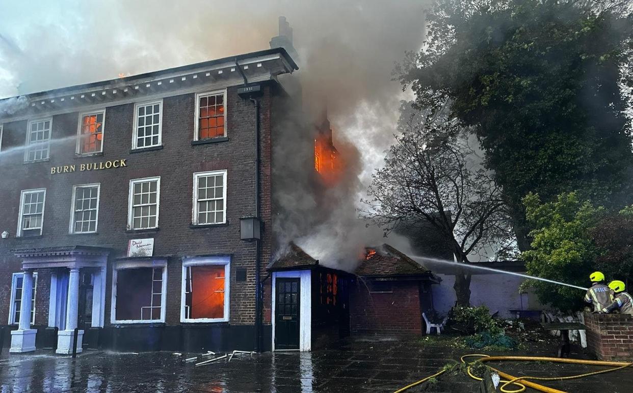 Firefighters hose down the pub as they try to extinguish the flames