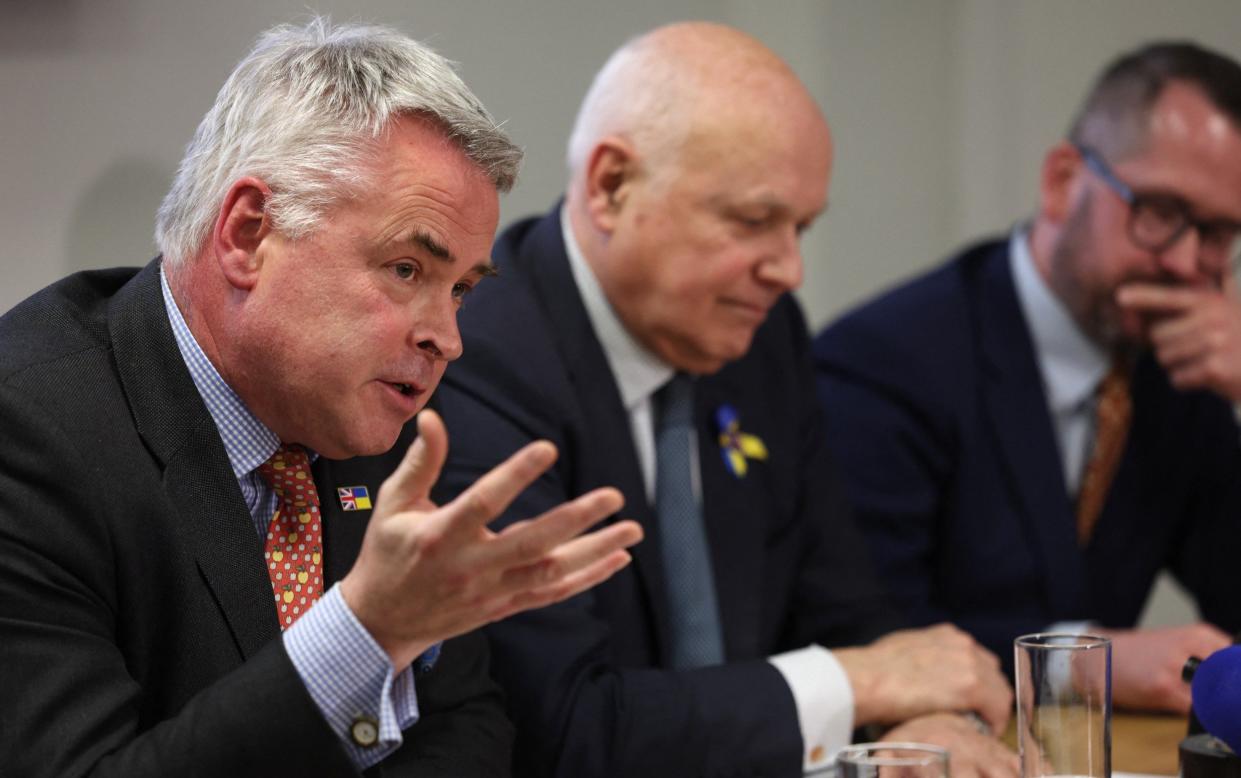 Tim Loughton gestures as he speaks next to Iain Duncan Smith