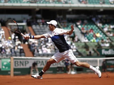 Kei Nishikori of Japan plays a shot to Thomaz Bellucci of Brazil during their men's singles match at the French Open tennis tournament at the Roland Garros stadium in Paris, France, May 27, 2015. REUTERS/Gonzalo Fuentes