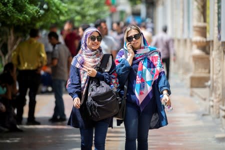 Iranian women walk at Ferdowsi street in Tehran