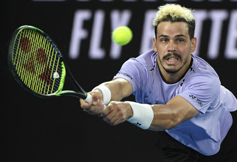 Australia's Alex Bolt makes a backhand return to Germany's Alexander Zverev during their third round match at the Australian Open tennis championships in Melbourne, Australia, Saturday, Jan. 19, 2019. (AP Photo/Andy Brownbill)