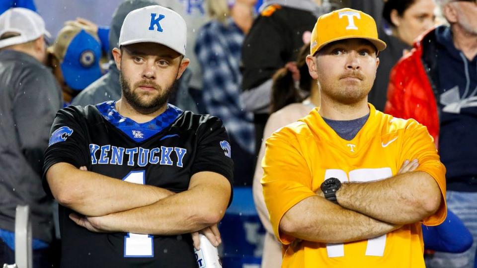 A Kentucky Wildcats fan and A Tennessee Volunteers fan in the stand during the second half of a football game at Kroger Field in Lexington, Ky., Saturday, Oct. 28, 2023. Tennessee never trailed on the way to a 33-27 victory that extended Kentucky’s losing streak to three games.