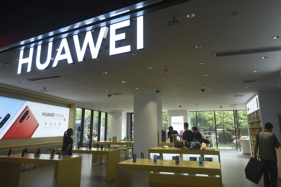 Shoppers browse smartphones at a Huawei retail store in Hangzhou in eastern China's Zhejiang province, Thursday, May 16, 2019. In a fateful swipe at telecommunications giant Huawei, the Trump administration issued an executive order Wednesday apparently aimed at banning its equipment from U.S. networks and said it was subjecting the Chinese company to strict export controls. (Chinatopix via AP)