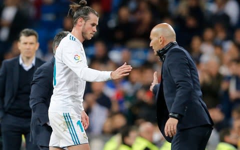 Real Madrid's Gareth Bale. left, shakes hands with Real Madrid's head coach Zinedine Zidane after being substituted during a Spanish La Liga soccer match between Real Madrid and Celta at the Santiago Bernabeu stadium in Madrid, Spain - Credit:  AP