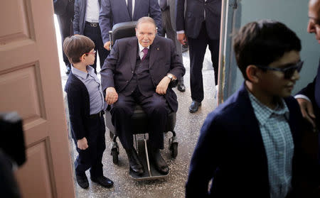 Algeria's President Abdelaziz Bouteflika arrives with his nephew to cast his ballot during the parliamentary election in Algiers, Algeria May 4, 2017. REUTERS/Ramzi Boudina