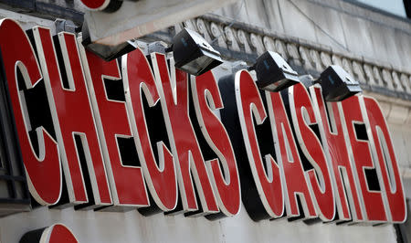 FILE PHOTO: A sign is seen above a check cashing and loan shop in Jersey City, New Jersey, June 2, 2016. REUTERS/Mike Segar