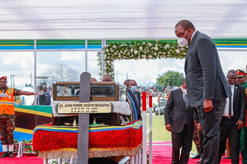 Kenya's President Uhuru Kenyatta pays respect at the coffin of the late Tanzanian President Magufuli during the State Funeral, in Dodoma