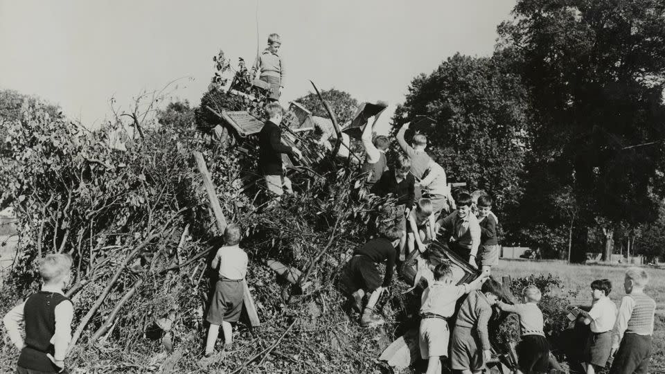 A photograph from 1955, depicting children at a school in Surrey, England, preparing the Guy Fawkes Night bonfire. - Hulton Archive/Getty Images