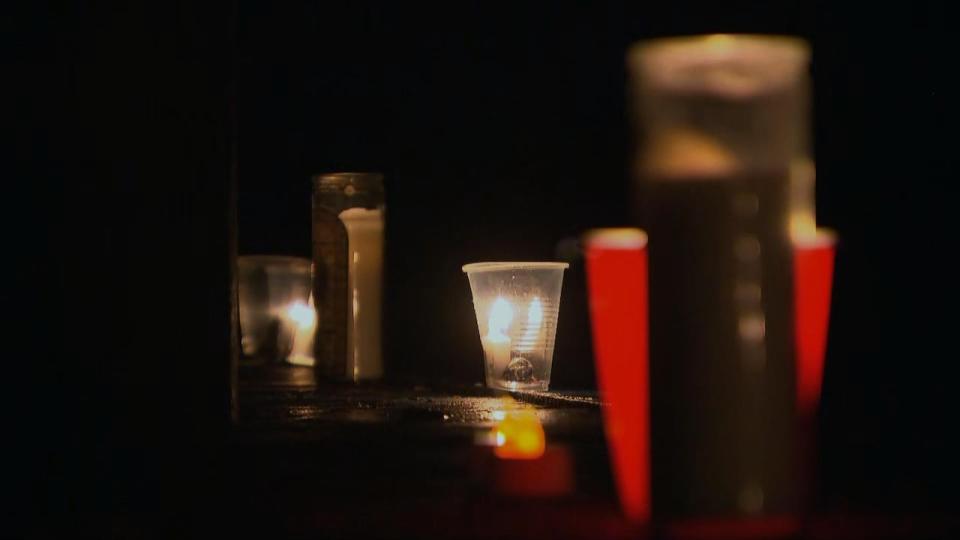 Candles perched by the Rideau River dock near Nicolls Island on Dec. 29, 2023 during a vigil for Riley Cotter and Ahmed Ahmed, two teens who died earlier that week after falling through thin ice.
