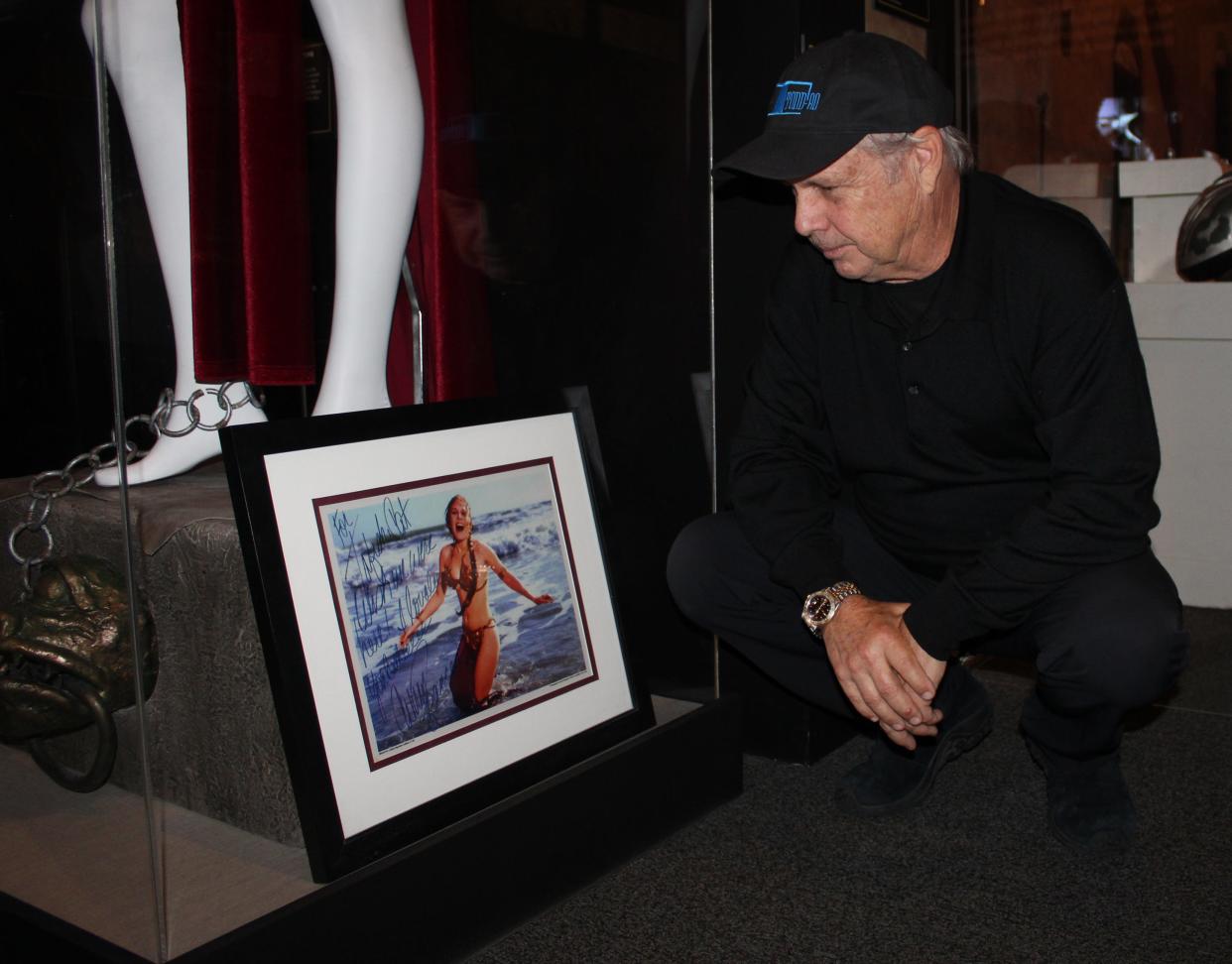 Todd Fisher looks at a photo of sister Carrie Fisher Tuesday on display at the Ronald Reagan Presidential Library & Museum in Simi Valley. The image is from a 1983 photo shoot at Stinson Beach, north of San Francisco. The actress, who played Princess Leia in the "Star War" movies, signed the photo for her brother.