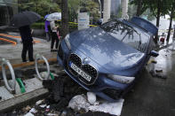 A vehicle sits damaged on a road after floating in heavy rainfall in Seoul, South Korea, Tuesday, Aug. 9, 2022. Heavy rains drenched South Korea's capital region, turning the streets of Seoul's affluent Gangnam district into a river, leaving submerged vehicles and overwhelming public transport systems. (AP Photo/Ahn Young-joon)