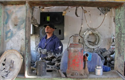 Mexican ex-soldier Ivan Castaneda -- separated from his wife and five children -- works in an auto shop awaiting appeal of his US deportation