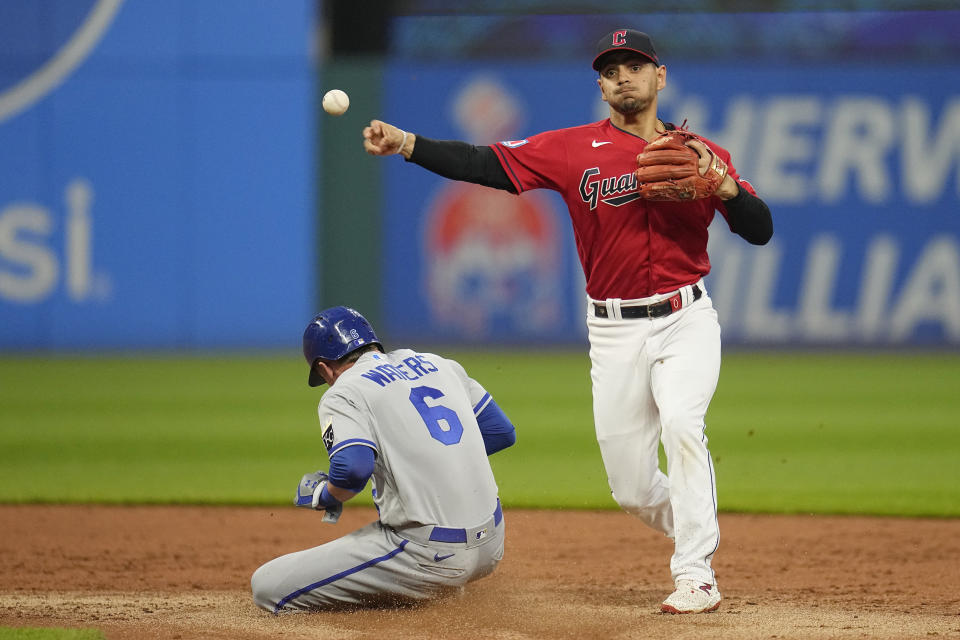 Cleveland Guardians second baseman Andres Gimenez throws to first base after forcing out Kansas City Royals' Drew Waters (6) on a ball hit by Dairon Blanco, who was safe during the second inning of a baseball game Thursday, July 6, 2023, in Cleveland. (AP Photo/Sue Ogrocki)