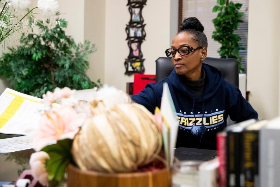 Shelby County Clerk Wanda Halbert hands a document to reporter Brooke Muckerman during an interview with The Commercial Appeal in her office in Memphis, Tenn., on Friday, January 5, 2024.