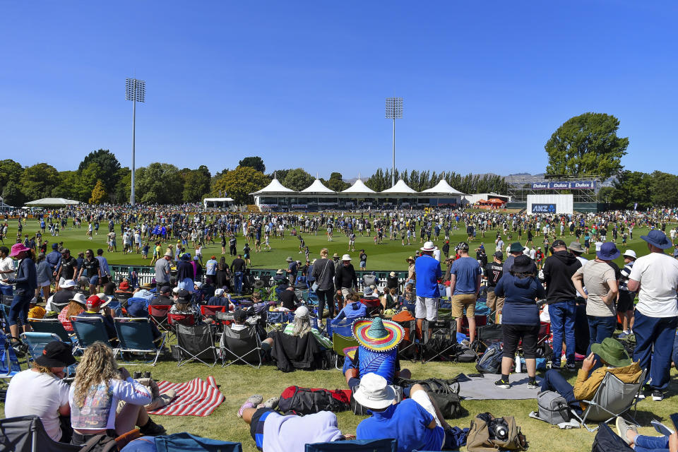 Spectators walk on the field during the lunch break on day three of the second cricket test between New Zealand and Australia in Christchurch, New Zealand, Sunday, March 10, 2024. (John Davidson/Photosport via AP)