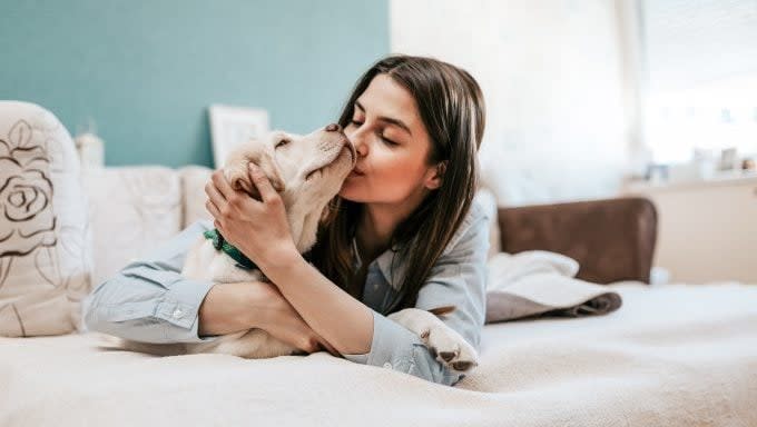 young woman hugging dog