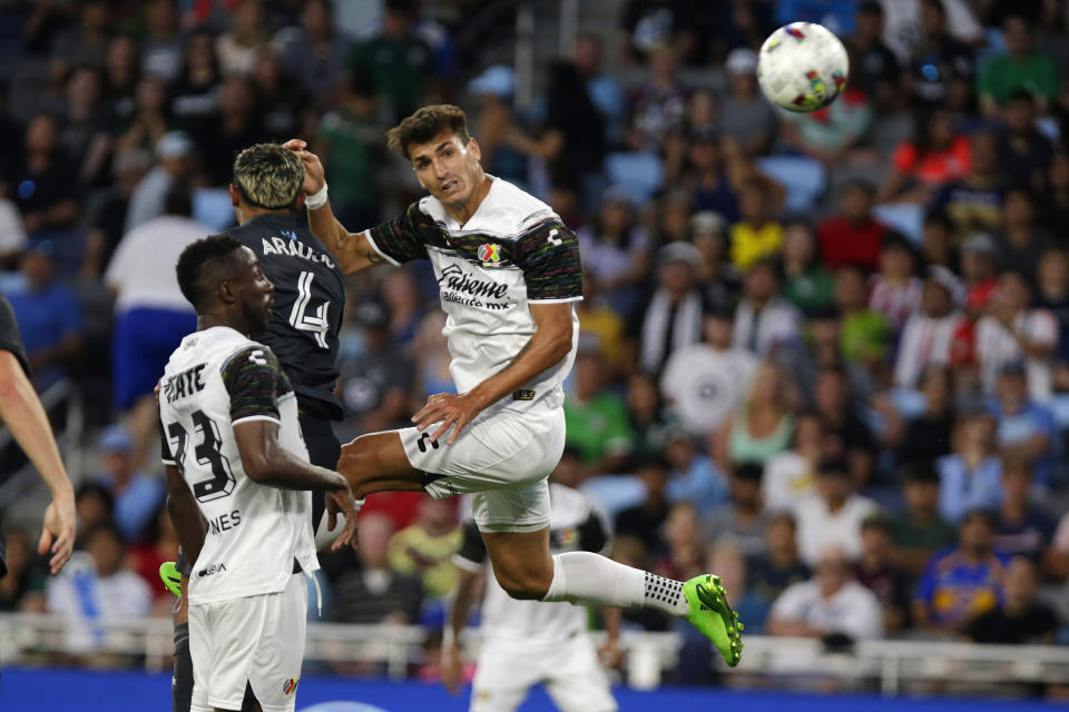 Liga MX All-Star Juan Dinenno, right, heads the ball next to MLS All-Star Julián Araujo (4), with Liga MX All-Star Luis Quiñones watching during the first half of the MLS All-Star soccer match Wednesday, Aug. 10, 2022, in St. Paul, Minn. (AP Photo/Andy Clayton-King)