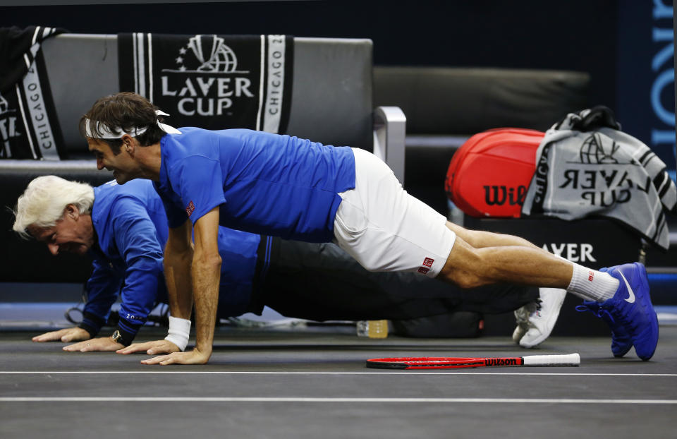 Team Europe's Roger Federer, front, and Bjorn Borg do pushups as they celebrate a men's singles tennis match win against Team World's John Isner at the Laver Cup, Sunday, Sept. 23, 2018, in Chicago. (AP Photo/Jim Young)