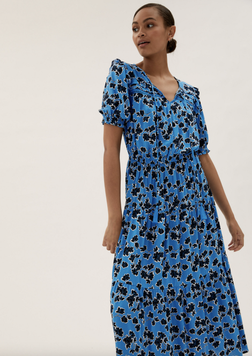 The Floral Tie Neck Midxi Waisted Dress boasts short puff sleeves, an elasticated waist and tie neck detail.  (Marks and Spencer)