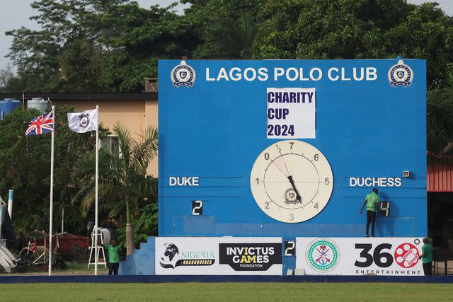 <p>KOLA SULAIMON/AFP via Getty</p> A referee adjusts the score of a charity polo game between "Team Duke" and "Team Duchess" during a charity polo game in Lagos, Nigeria, on May 12, 2024