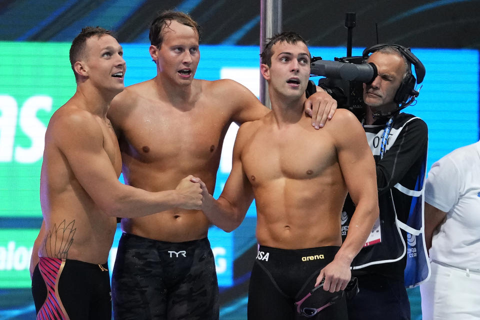 Members of team United States celebrate after winning the men's 4x100m freestyle relay final at the 19th FINA World Championships in Budapest, Hungary, Saturday, June 18, 2022. (AP Photo/Petr David Josek)