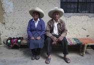 Ireño Castillo and Mavila Terrones, the parents of Free Peru party presidential candidate Pedro Castillo, pose for a portrait in their home in Puna, Peru, Friday, April 16, 2021. Their son, who has proposed rewriting Peru's constitution and deporting all immigrants living in the country illegally who commit crimes, will face rival candidate Keiko Fujimori in the June 6 presidential run-off election. (AP Photo/Martin Mejia)