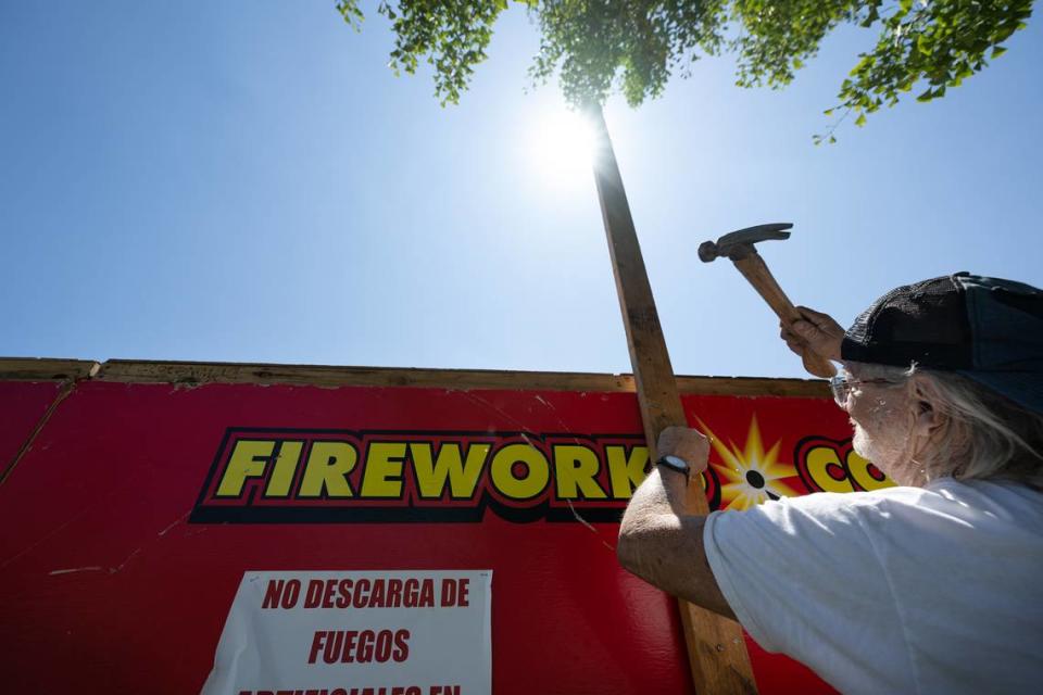 Will Plumley finishes assembling a fireworks stand at 1800 Oakdale Road in Modesto, Calif., Wednesday, June 21, 2023. Local nonprofit Knights of Columbus will sell fireworks out the stand on Oakdale Road.