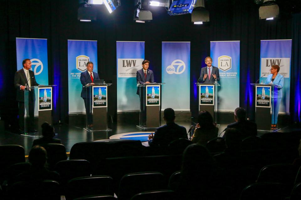 From left to right, Rick Caruso, Joe Buscaino, Kevin de Leon, Mike Feuer and Karen Bass participate in a Los Angeles mayoral debate at the Student Union Theater on the California State University, Los Angeles campus on May 1.