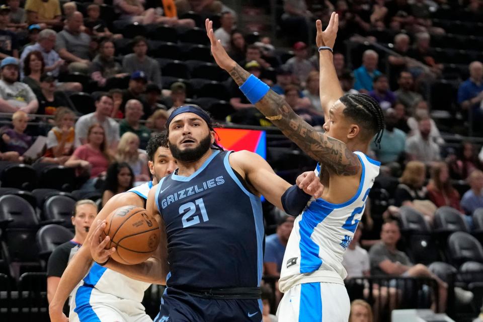 Memphis Grizzlies forward David Roddy (21) drives as Oklahoma City Thunder guard Tre Mann, right, defends during the first half of an NBA summer league basketball game Wednesday, July 5, 2023, in Salt Lake City. (AP Photo/Rick Bowmer)
