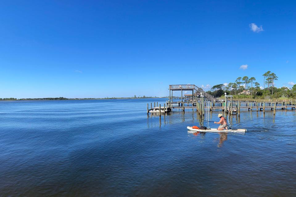 A paddle boarder makes his way from boat launch at Sleepy Hollow Drive in Mary Esther. The Fort Walton Beach Police Department is looking to create a marine unit to help combat a high number of boating accidents in the county.