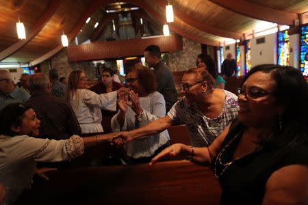 Puerto Ricans attend a Spanish Mass conducted by Father Jose Rodriguez at the Episcopal Church Jesus of Nazareth, in Orlando, Florida, U.S., November 26, 2017. REUTERS/Alvin Baez