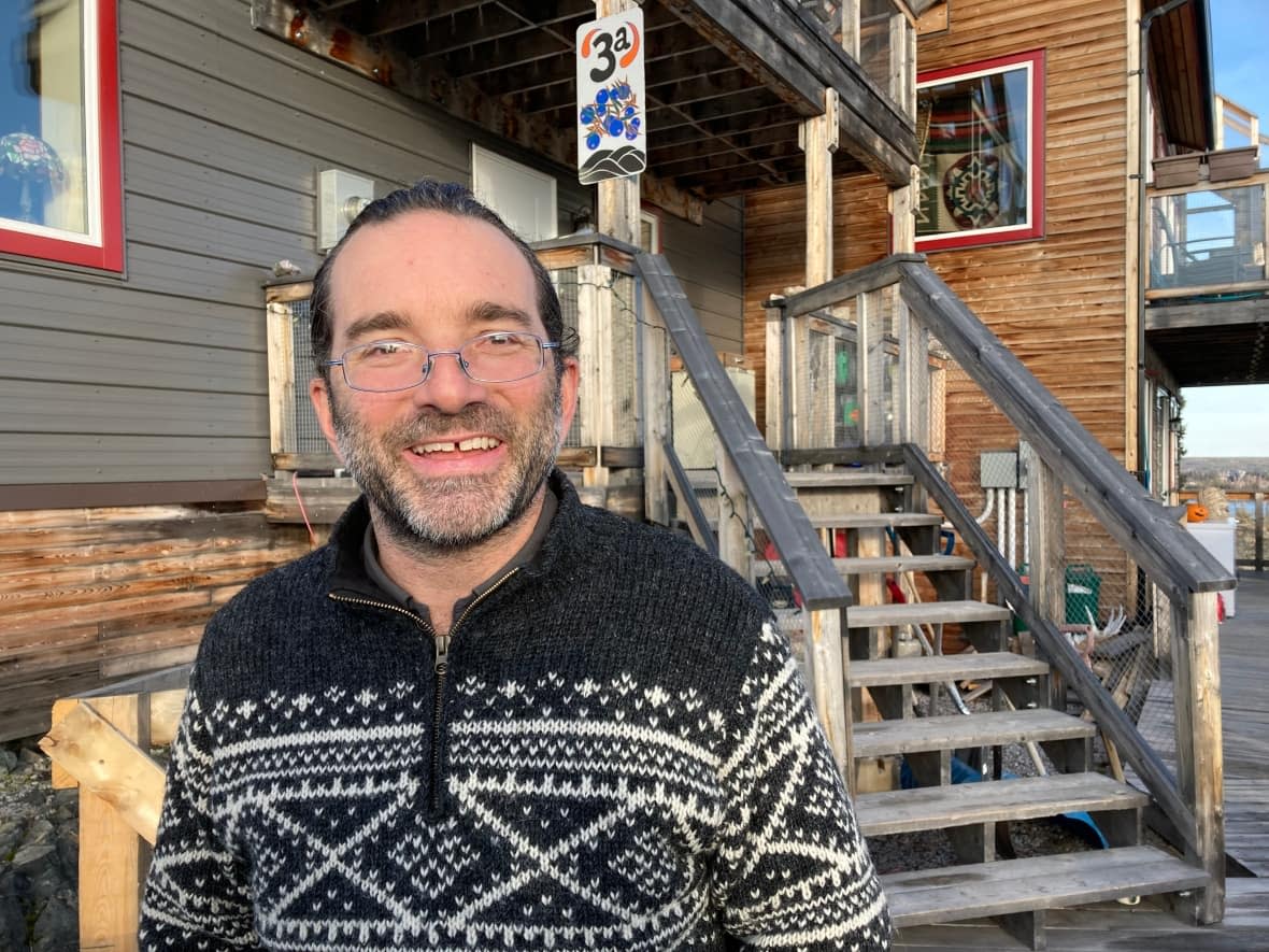 Andrew Robinson says he became carbon neutral in 2007 by buying carbon offsets, but over the years he's been able to make other changes in his life to reduce the emissions he creates — like building a highly energy-efficient home and buying an electric bike.  (Liny Lamberink/CBC - image credit)