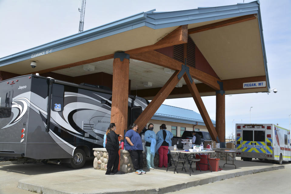 In this Wednesday, April 28, 2021, photo, Blackfeet tribe nurses take a brief break from administering COVID-19 vaccines at the Piegan-Carway U.S. Customs and Border Protection border port of entry between Montana and Canada, near Babb, Mont. The Blackfeet tribe gave out surplus vaccines to its First Nations relatives and others from across the border. (AP Photo/Iris Samuels)