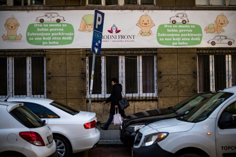 A woman walks in front of a maternity hospital in Belgrade. The government wants to boost the country's birth rate of 1.5 children per family, one of the lowest in Europe