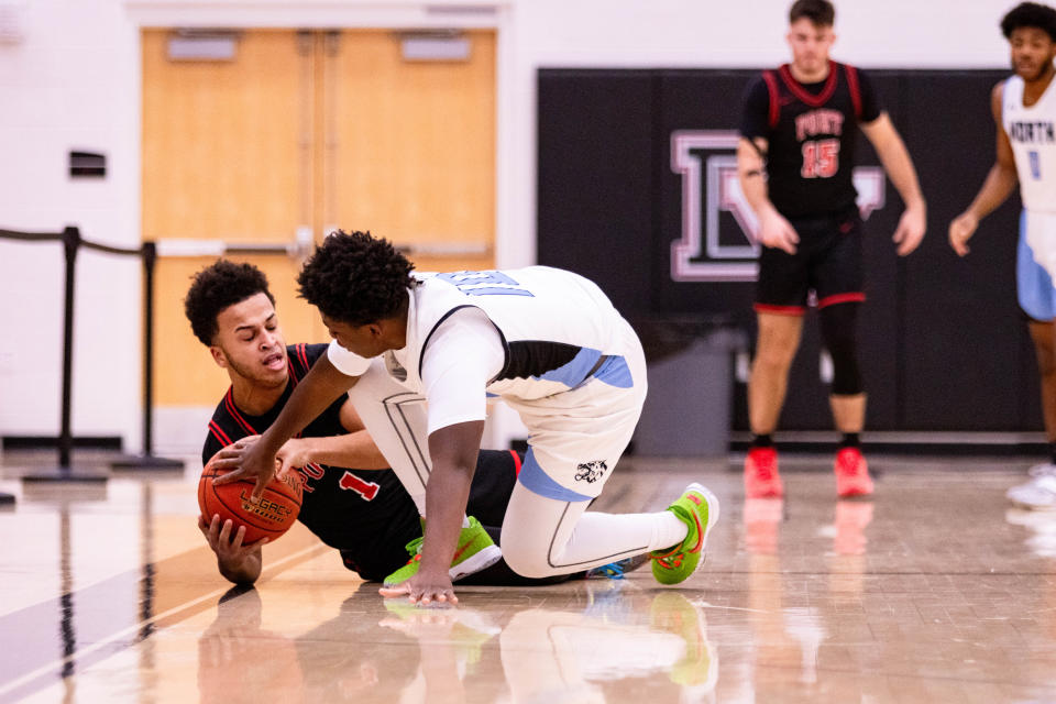 East Stroudsburg North's Bernard Bowen (10) tries to steal the ball from Port Jervis' Isaiah Boucher (1) after he falls to the ground on December 27, 2023