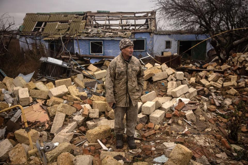 <div class="inline-image__caption"><p>Anatoly Sikoza who buried the bodies stands amid the rubble of a house where Russian forces killed seven men and one woman, hands bound, blindfolded and shot at close range, before blowing up the site in a bid to cover the killings in a village on the outskirts of Kherson on Nov. 27, 2022 in Kherson, Ukraine.</p></div> <div class="inline-image__credit">Chris McGrath/Getty Images</div>