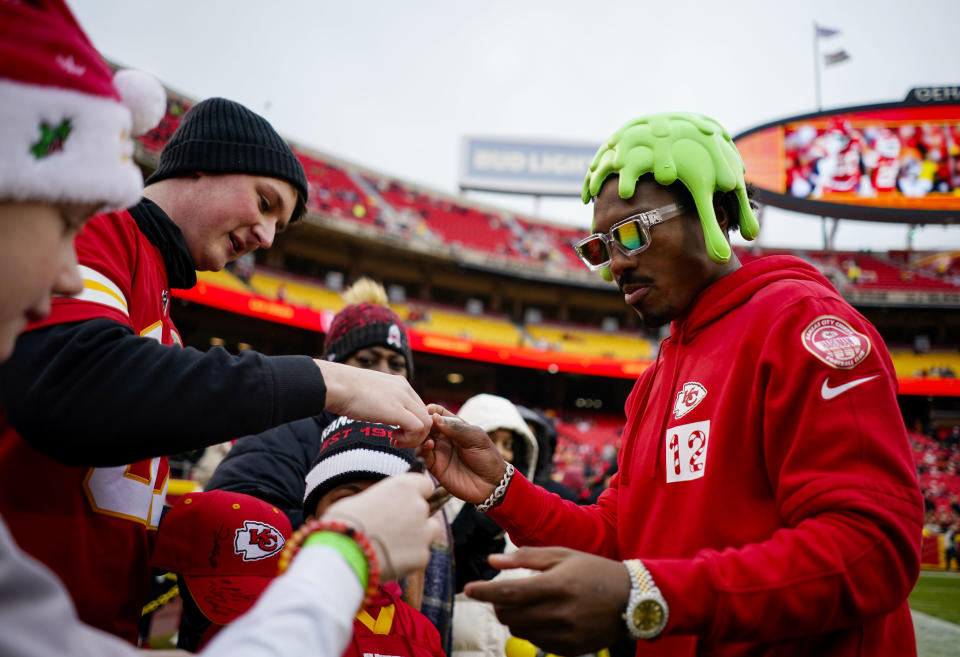 Dec 25, 2023; Kansas City, Missouri, USA; Kansas City Chiefs wide receiver Mecole Hardman Jr. (12) signs autographs prior to a game against the Las Vegas Raiders at GEHA Field at Arrowhead Stadium. Mandatory Credit: Jay Biggerstaff-USA TODAY Sports